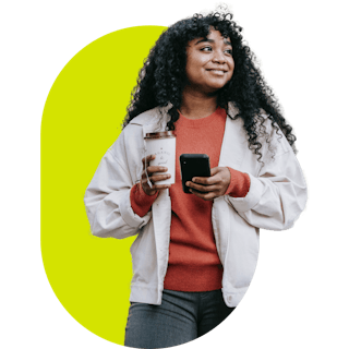 Person holding a phone and coffee cup.